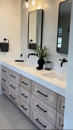 a large bathroom with two sinks and mirrors on the wall next to eachother