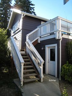 a house with stairs leading up to the front door