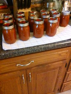 many jars are lined up on the counter