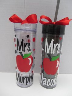 two personalized tumblers with red bows and the words mr and mrs on them