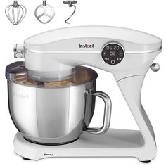 an image of a white mixer with ingredients in it and attachments to the side