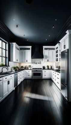 a large kitchen with white cabinets and black floors is lit by recessed lights in the ceiling