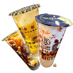 three plastic cups with different designs on them