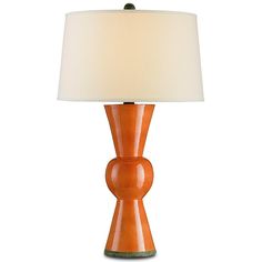 an orange table lamp with a white shade on the base and a light in front of it