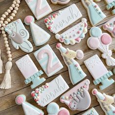 decorated cookies are arranged on a wooden table