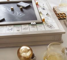 a board game sitting on top of a table next to some glasses and other items