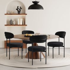 a round table with four black chairs and a white rug on the floor in front of it