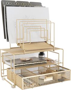 a gold metal desk organizer with three drawers and two trays on each side, holding various items