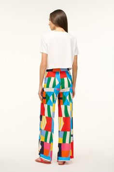 Stand out at the pool with the Copano Pant by Staud. The geometric mesh print is an eye-catcher. Pair with a white or black swimsuit, and even a white tee if you need to escape the sun. Bold Multicolor Summer Pants, Modern White Bottoms For Summer, Modern White Summer Bottoms, Chic Bold Print Summer Pants, Bold High-waisted Summer Pants, Casual Summer Pants With Bold Print, Bold High-waisted Summer Bottoms, Bold High-waisted Pants For Summer, Chic Summer Bottoms With Geometric Pattern