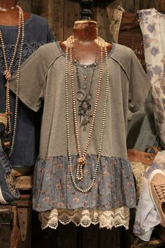 an assortment of clothing and necklaces on display