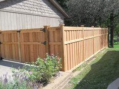 a large wooden fence next to a house