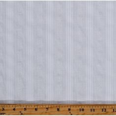 a ruler is next to a piece of white fabric