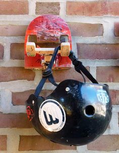 a helmet and skateboard mounted to a brick wall