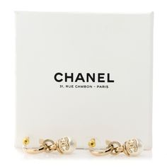 This is an authentic pair of CHANEL Crystal CC Pearl Drop Earrings in Gold. These stunning earrings feature a hanging resin pearl with a Chanel CC logo encrusted with crystals. Resin Pearl, Pearl Drop Earrings Gold, Drop Earrings Gold, Earrings In Gold, Stunning Earrings, Cc Logo, Pearl Drop Earrings, Pearl Drop, Earrings Gold