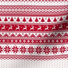 a red and white knitted christmas sweater with reindeers, trees and snowflakes