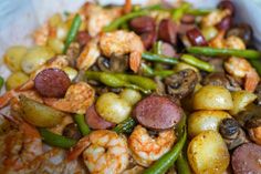 shrimp, potatoes and green beans in a white bowl