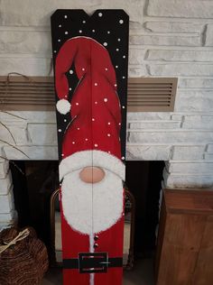 a wooden santa clause standing in front of a fireplace