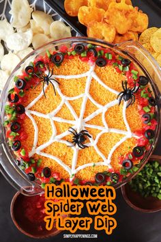 a halloween spider web cake is decorated with candy and sprinkles