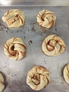 six cinnamon buns on a baking sheet ready to go into the oven