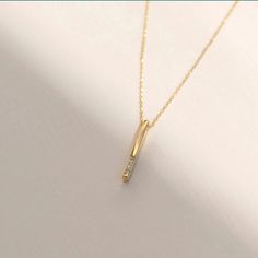 Introducing the Diamond Vertical Bar Necklace in 14k Solid Gold, this piece is designed for those who appreciate classic simplicity and seek a versatile layering accessory. It's the secret ingredient that complements any outfit, offering an elegant and timeless touch. This necklace is the essential personalized addition to your jewelry collection. Here are the key details: Handcrafted from 14k solid gold All materials are sourced from the United States Size Information: Material: 14k Solid Gold Diamond Type: Natural Diamond Quality: Carat Weight: 0.01 carats Color: F-G Clarity: VS2 Cut: Excellent Pendant Height: 15 mm / 0.59 inches Pendant Width: 1 mm / 0.03 inches Chain Style: Cable Chain Chain Length: 18 inches Each piece includes a certificate of authenticity, and the product undergoes Elegant Diamond Necklace With Rectangular Pendant For Formal Occasions, Elegant Rectangular Diamond Cut Pendant Necklaces, Elegant Necklaces With Rectangular Diamond Cut Pendant, Elegant Rectangular Pendant Necklaces With Diamond Cut, Elegant 14k Gold Bar Necklace With Cable Chain, Elegant 14k Gold Diamond Necklace With Clavicle Chain, Elegant Necklace With Rectangular Pendant And Cable Chain, Classic Bar Necklace With Diamond Accents, Elegant Rectangular Pendant Necklace With Cable Chain