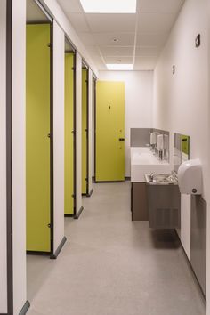 a row of stalls with sinks and urinals next to each other in a bathroom