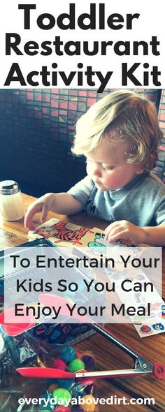 a toddler is sitting at a table and playing with an activity kit for kids