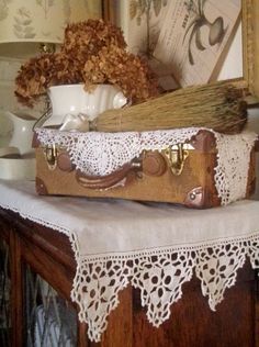 two pieces of luggage sitting on top of a wooden table in front of a mirror