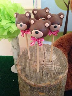 there are four brown bears on top of sticks