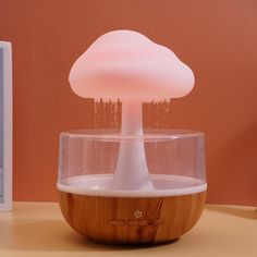 a mushroom shaped light sitting on top of a wooden table