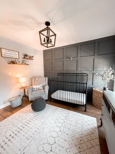 a baby's room with a crib, chair and rug