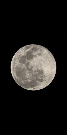 an airplane flying in the sky with a full moon behind it's back end