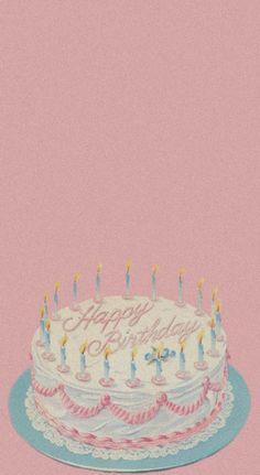 a birthday cake with lit candles on it sitting in front of a pink background that says happy birthday