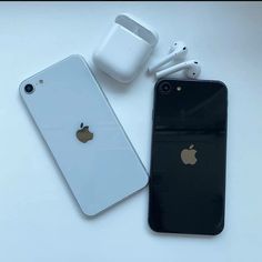 an iphone and ear buds sitting next to each other on top of a white table