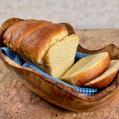 a loaf of bread sitting in a bowl on top of a counter