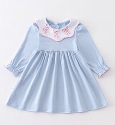 This beautiful blue dress is perfect for any little ballerina out there. With exquisite embroidered ballet shoes accents, it's sure to capture the attention of anyone who sees it. The dress is knee-length, has long sleeves, and is made in a solid pattern. It's designed for girls aged 5 and comes with tags attached. You'll love the attention to detail in this dress, making it ideal for any special occasion. The dress is perfect for adding a touch of elegance to any wardrobe and is ideal for any g Cute Blue Embroidered Dress, Casual Blue Dress With Embroidered Hem, Little Ballerina, Shoes Dress, Girls Clothes, Solid Pattern, Blue Dress, Beautiful Blue, Dress Making