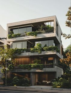 an apartment building with plants growing on the balconies