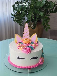 there is a cake decorated with flowers and a unicorn face