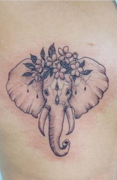 an elephant with flowers on it's head is seen in this tattoo design by kary