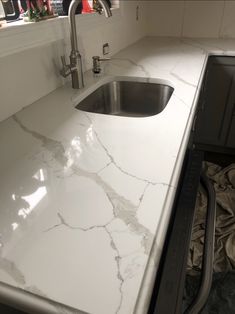 a kitchen counter top with a sink and faucet in the corner next to it