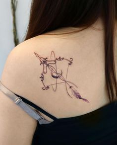 a woman with a tattoo on her shoulder