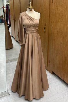 Feel like a goddess in this stunning champagne-colored one-shoulder dress featuring a flared sleeve, banded waist, and A-line silhouette. Perfect for any formal occasion, this long dress is sure to turn heads and make you look fabulous. Make a statement at your special event as the best-dressed mother of the bride or wedding guest.#wedding#weddingguestdresses#motherofthebridedresses#motherofthegroomdresses#mother’sgown Beige One-shoulder Dress For Formal Occasions, Beige One-shoulder Evening Dress, Beige One Shoulder Evening Dress, Beige One-shoulder Wedding Dress, Beige One-shoulder Dress For Wedding, Red Prom Dress Elegant, Wedding Swimwear, Mothers Gowns, Satin Evening Dresses