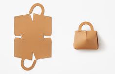 a handbag next to a cut out piece of paper with holes in it and a bag hanging on the wall