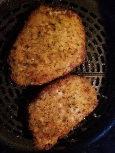 two fried meat patties in a frying pan