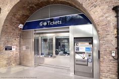 an entrance to a train station with a ticket machine