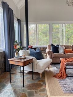 a living room filled with furniture and lots of windows