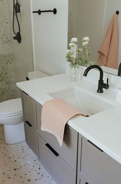 a bathroom with a sink, toilet and shower