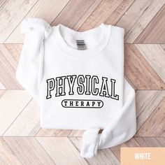 Physical Therapist Sweatshirt, PT Sweatshirt, Physical Therapist Gift, Physical Therapy Assistant PTA Grad Gift, Doctor Of Physical Therapy *PRODUCTION TIME* 1-6 days (Usually 2 days) *SHIPPING TIME* 2-5 days *PRODUCT DESCRIPTION* *Bella Canvas Unisex T-shirt Super soft cotton and excellent quality print makes. 100% Soft cotton (fibre content may vary for different  colors) Light fabric (4.2 oz/yd² (142 g/m Runs true to size Retail fit Our Relaxed Fit Tee (Bella + Canvas style 3001) is a  unisex style  that runs a touch small for men, and  about a half a size large for women. It's a relaxed fit  and is soft and cozy. *Unisex Sweatshirt 50% cotton, 50% polyester Loose fit Runs true to size Sewn-in label *CARE INSTRUCTION* Machine wash: warm (max 40C or 105F); Non-chlorine:  bleach as needed White Graphic Print Sweats With Relaxed Fit, White Graphic Print Sweats Relaxed Fit, White Relaxed Fit Sweats With Graphic Print, White Crew Neck Sweater For College, White Sporty Sweats With Letter Print, White Crew Neck Sweatshirt With Text Print, Sporty White Sweats With Letter Print, White Relaxed Fit Crew Neck Sweats, Basic Sweatshirt With Letter Print