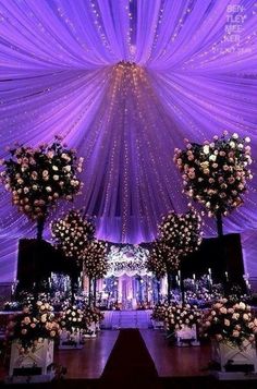 an aisle decorated with flowers and lights