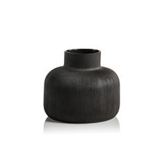 a black vase sitting on top of a white surface