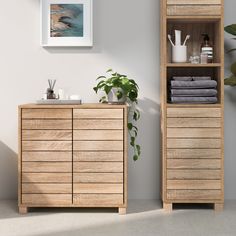 a wooden cabinet next to a potted plant